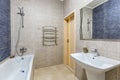 Bathroom with shower, bathtub and light tiles