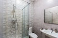 Bathroom with shower, bathtub and light tiles