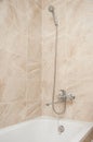 Bathroom with shower diffuser and faucet assembly. Design and interior with nice brown tiles on the walls