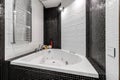 Bathroom with shower and large Jacuzzi bathtub with contrasting white and black walls Royalty Free Stock Photo