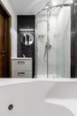 Bathroom with shower and large Jacuzzi bathtub with contrasting white and black walls Royalty Free Stock Photo