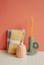 Bathroom shower towel and toothbrush, candle on white table. pink wall background Royalty Free Stock Photo