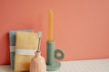 Bathroom shower towel and toothbrush, candle on white table. pink wall background Royalty Free Stock Photo