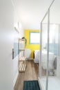 Bathroom with a shower with yellow and light blue wall