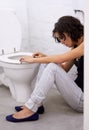 Bathroom, sick and woman on a floor suffering from anorexia, depression or anxiety. Stress, toilet and female with body Royalty Free Stock Photo