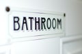 Bathroom sign on white door label