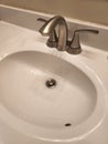 Bathroom sink with brand new brushed nickel faucet.