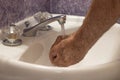 Bathroom sink cupping hands under running water Royalty Free Stock Photo