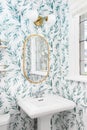 A bathroom detail with a floral pattern wallpaper.