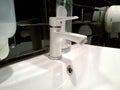 Bathroom sink and faucet in public toilet and restroom. Modern white color taps. Virus protection concept. Sanitary rules and requ