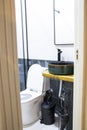 an enclosed bathroom with sink, toilet and black and white tile Royalty Free Stock Photo