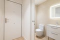 Bathroom with sliding door separating toilet from corridor