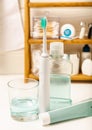 Bathroom with sonic electric toothbrush, toothpaste, mouthwash, dental floss and tongue cleaner Royalty Free Stock Photo