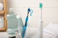 Bathroom with sonic electric toothbrush, toothpaste, mouthwash, dental floss and tongue cleaner Royalty Free Stock Photo