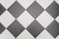 Bathroom tiles in black and white laid out in diamond pattern