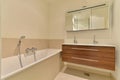 a bathroom with a tub and a sink and mirror Royalty Free Stock Photo