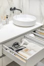Bathroom under sink organizer drawers with neatly placed bath amenities and toiletries. Royalty Free Stock Photo