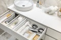 Bathroom under sink organizer drawers with neatly placed bath amenities and toiletries. Royalty Free Stock Photo