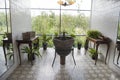 Restroom with many green plants and view to green nature out of large windows