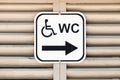 Bathroom or water closet or WC sign for handicapped wheelchair accessible restroom or toilet on wooden wall Royalty Free Stock Photo
