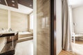 Bathroom with whirlpool tub and polished marble cladding