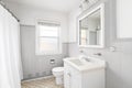 A bathroom with a white cabinet and brown and grey tiles. Royalty Free Stock Photo