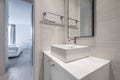 Bathroom with white lacquered cabinet and white stone