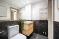 Bathroom with white porcelain sink on hanging wooden cabinet Royalty Free Stock Photo