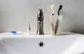 Bathroom white sink, faucet and hygienic set Royalty Free Stock Photo