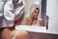 In the bathroom. Woman in white towel in head have care of herself Royalty Free Stock Photo