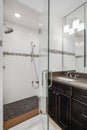 A bathroom with a wood cabinet and tiled shower. Royalty Free Stock Photo