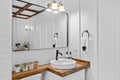 Bathroom wooden white interior design featuring a countertop next to a large wall mirror Royalty Free Stock Photo