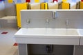 Bathrooms of a school for children with low ceramic sinks Royalty Free Stock Photo