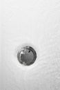 bathtub drain with water and bubbles Royalty Free Stock Photo