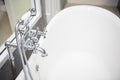 Bathtub with faucet and shower in bathroom Royalty Free Stock Photo