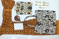 batik clotes with canting, small pan and wax earthenware glass  on white background Royalty Free Stock Photo
