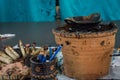 Batik tools, Canting and hot wax on top of wood table for Batik processing with blue wall as background photo taken in