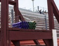 Batons in a medal basket with bleachers behind