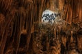 Bats handing upside down in beautiful cave formations with stalagmites and stalactites deep under ground