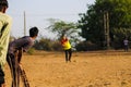 A batsman playing game of cricket,best man beautiful of four run shot,young boy playing cricket in rural area in evening time,