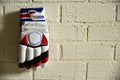 Batsmen gloves hanging on brick wall. sport wallpapers and background. Royalty Free Stock Photo