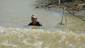 Battambang, cambodia - circa january 2024: local fisherman catching fish in the tonle sap river