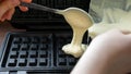 Batter Being Poured into Preheated Waffle Maker. Royalty Free Stock Photo