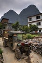 Battered ancient farmer tractor stands in peasant village, Guangxi, China.