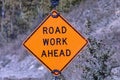 Battered sign warns ROAD WORK AHEAD in Glacier National Park