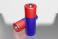 Batteries with a blue case with a metal contact plus and a red top on a white background with mirror reflection