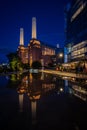 Battersea, London, UK: Battersea Power Station at night with reflection Royalty Free Stock Photo
