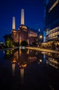 Battersea, London, UK: Battersea Power Station at night with reflection Royalty Free Stock Photo