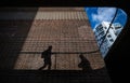 Battersea, London, UK: Shadows of people on a brick wall