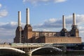 Battersea Power Station on the River Thames with a passing railway train showing public transport infrastructure Royalty Free Stock Photo